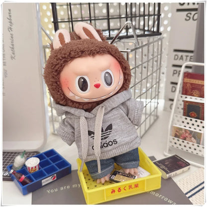 Plush toy with a hoodie and bunny ears on a desk
