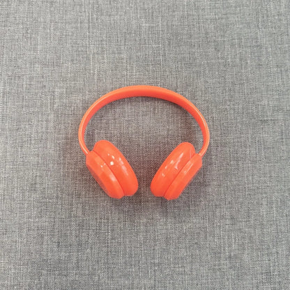 Orange headphones on a gray textured background