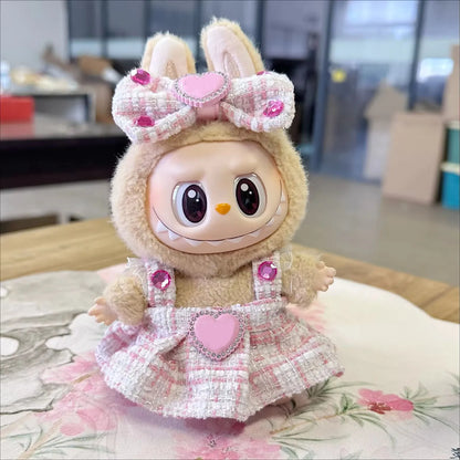 Toy figure with bunny ears and a pink dress on a floral cushion