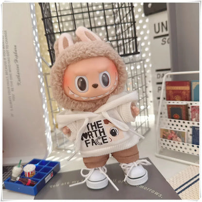 Plush toy wearing a 'The North Face' hoodie in a room setting