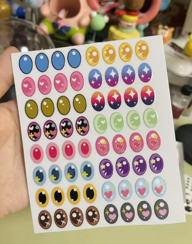 Sheet of colorful stickers with various designs held by a hand.