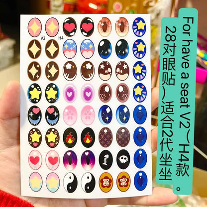 Sheet of colorful eye stickers held by a hand with text on a green label.