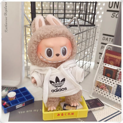 Plush toy with a hoodie and Adidas logo in an indoor setting
