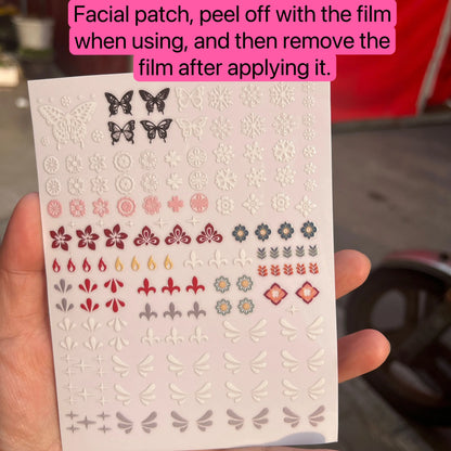 Sheet of decorative stickers with butterflies and flowers held by a hand.