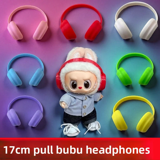 Colorful headphones displayed around a small doll wearing red headphones on a gradient background.