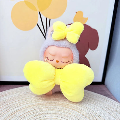 Plush toy with yellow bow on a textured surface